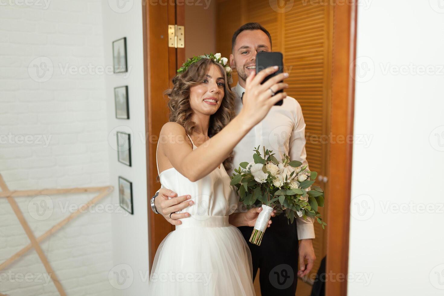 Romantic and happy caucasian couple in stylish clothes taking selfie on the background of beautiful room. Love, relationships, dating, romance, happiness concept. Man and woman having fun together. photo