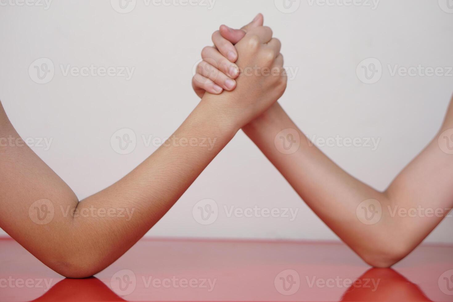 Close up two hands clasped arm wrestling. Concept, strength comparison competition. Strong body strengthen challenge recreation activity for competitive fun game. photo