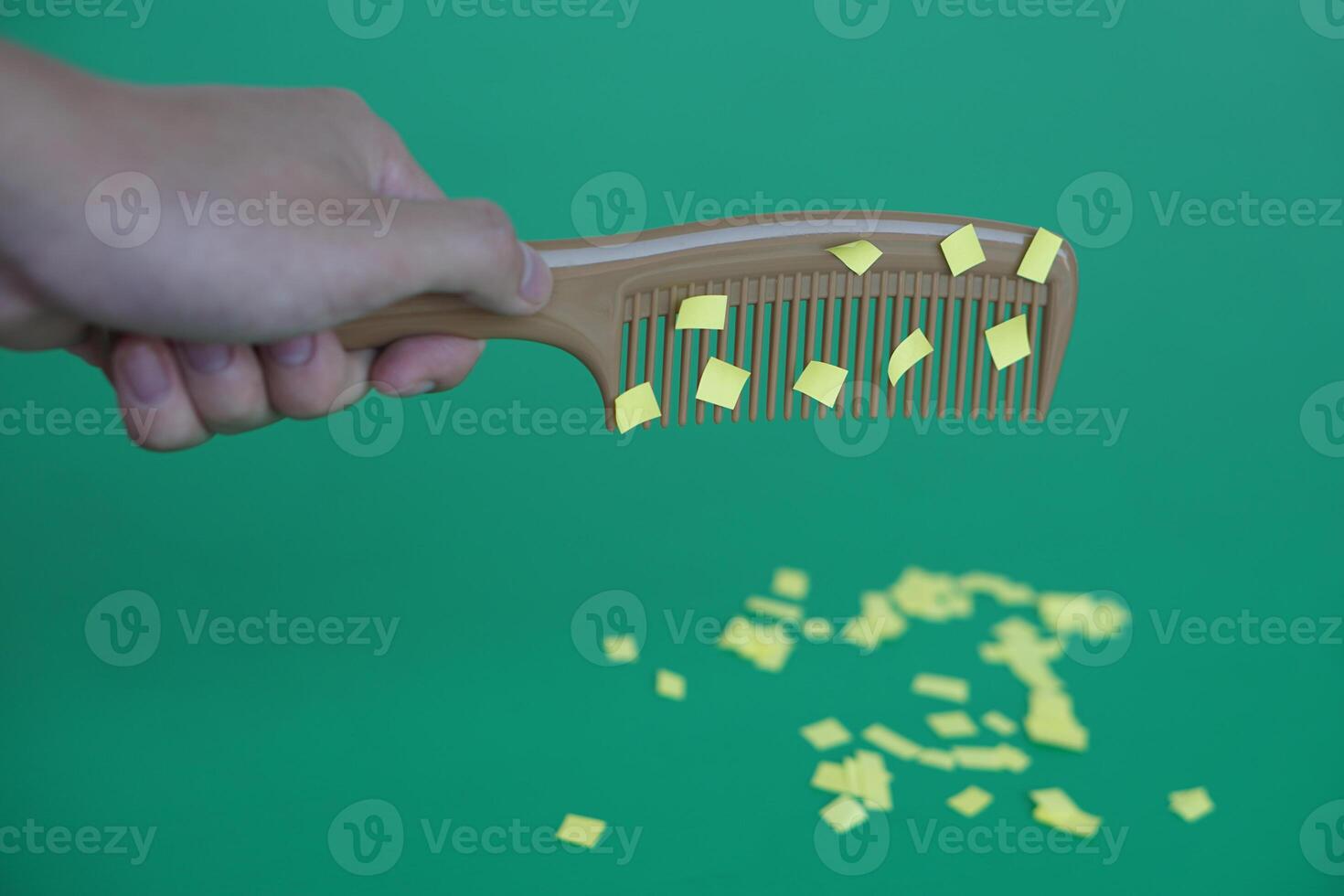 Comb and small pieces of paper. Equipment, prepared to do experiment about static electricity. Green background. Concept, Science lesson, fun and easy experiment. Education. Teaching aids. photo