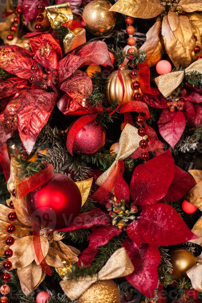 Close up of Christmas tree with ornaments of baubles, snowflakes, sleighs, lights. photo