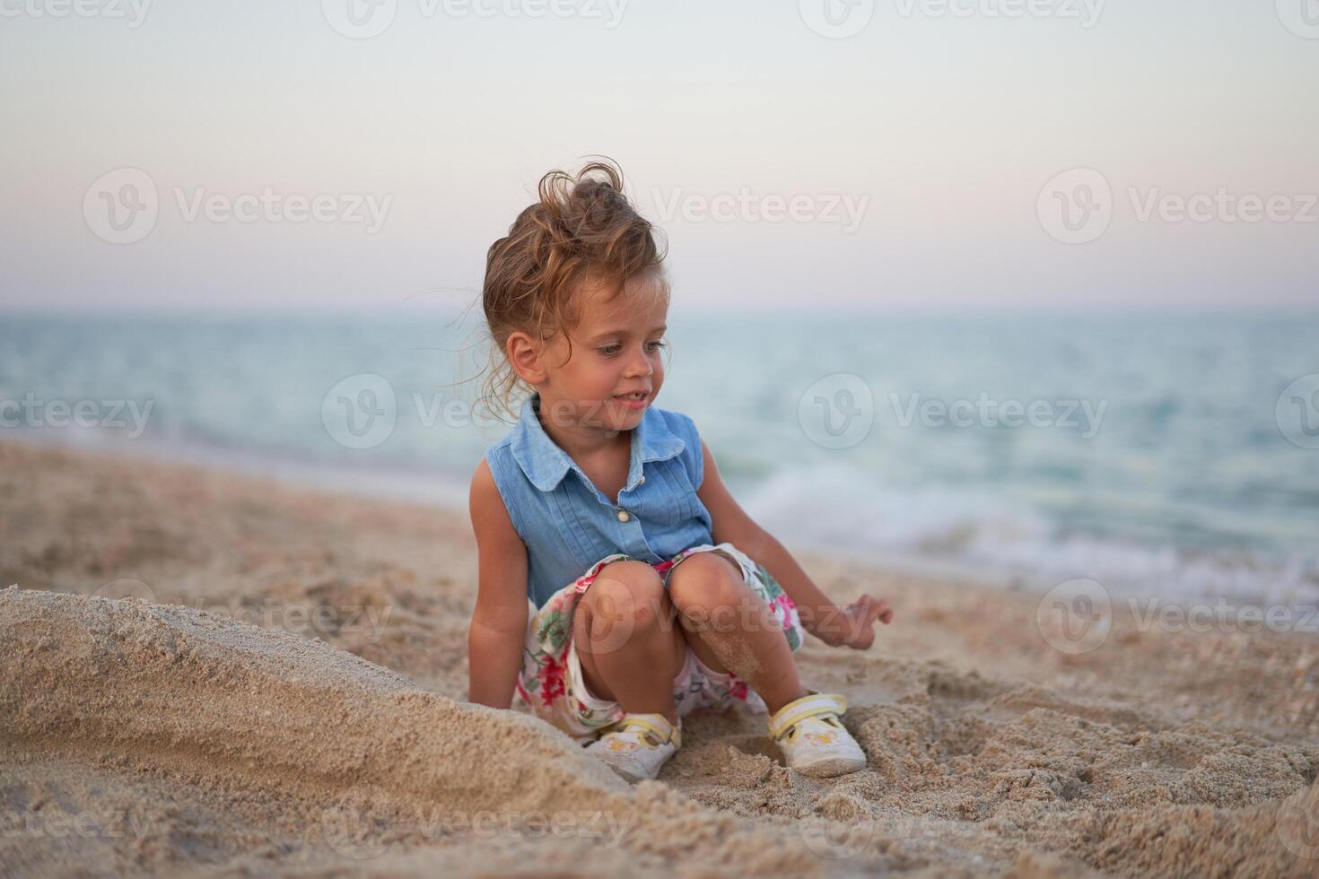 Child playing sand beach Little girl play sad alone summer family vacation photo