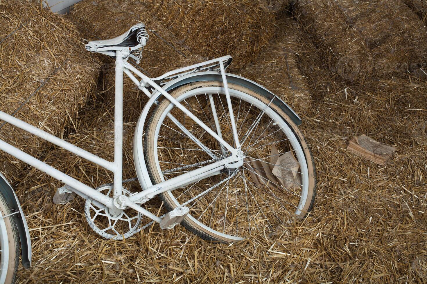 Old bicycle with hay bale with retro effect photo
