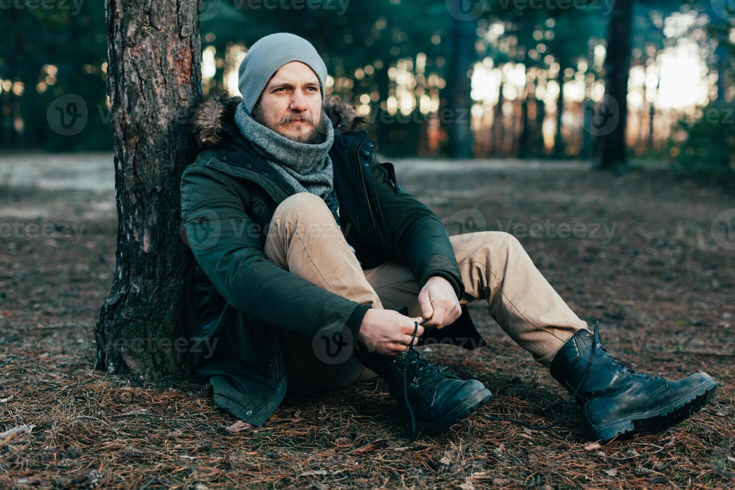 Pensive hipster guy wanderlust with touristic backpack enjoy tranquility during exploring nature environment, male hiker thinking about route to discover photo