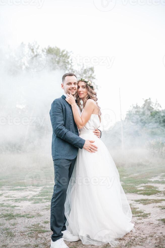 Bride and groom at wedding Day walking Outdoors on summer nature. Bridal couple, Happy Newlywed woman and man embracing in green park. Loving wedding couple outdoor. Bride and groom photo