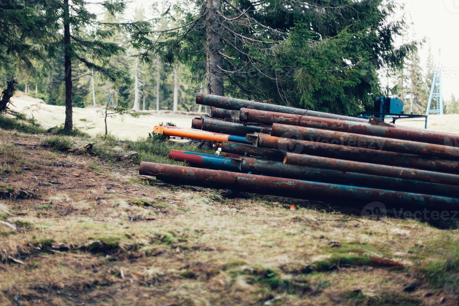 Rusty metal pipes in the forest closeup photo