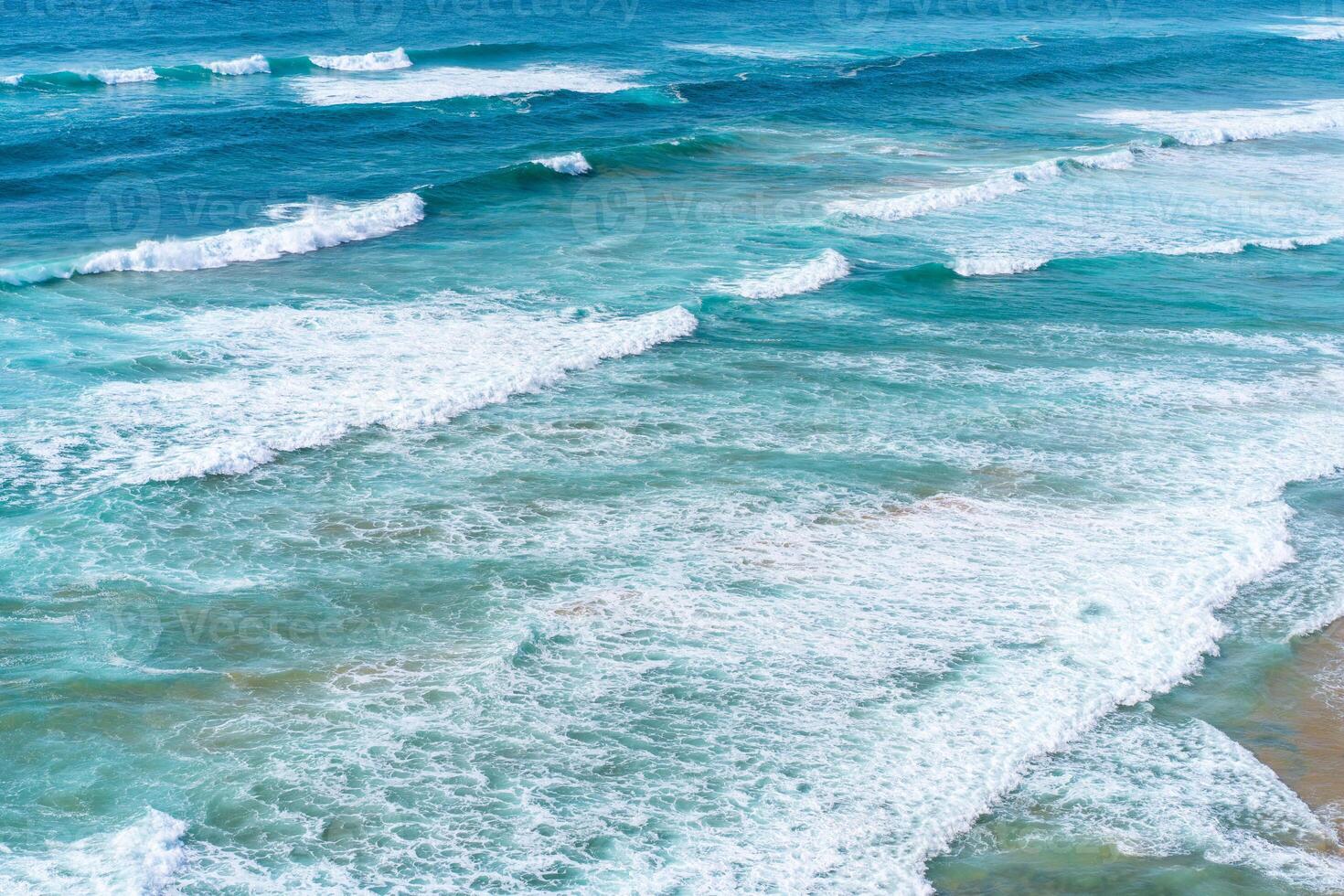 Aerial view of tropical sandy beach and ocean with turquoise water with waves. Sunny day on Atlantic ocean beach photo