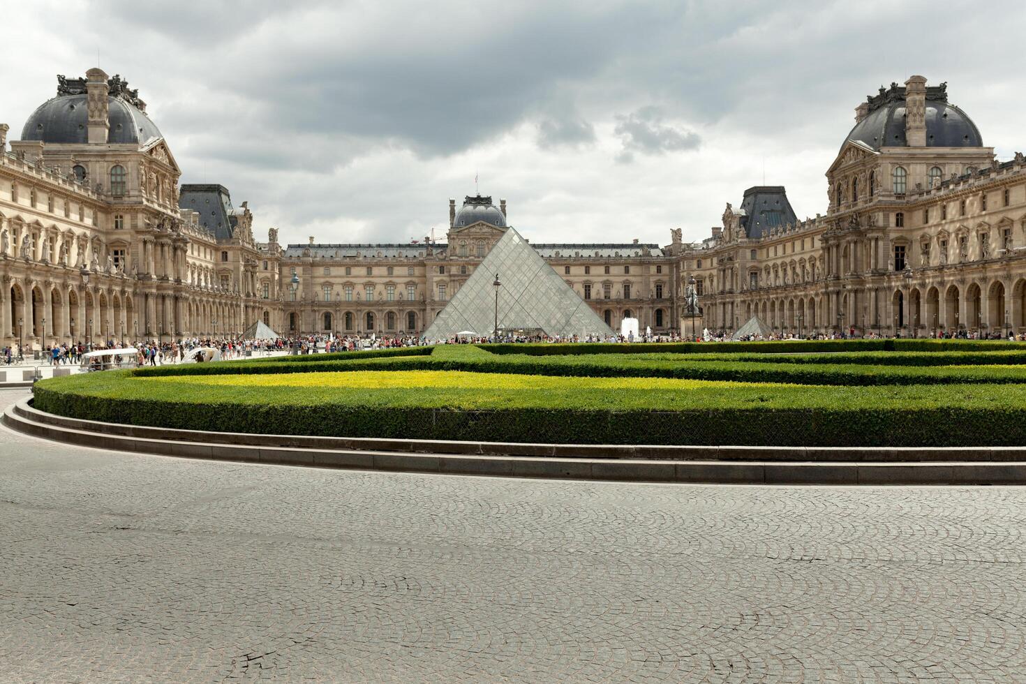 PARIS, FRANCE - June 01, 2018 View of famous Louvre Museum with Louvre Pyramid at evening sunset. Louvre Museum is one of the largest and most visited museums worldwide photo