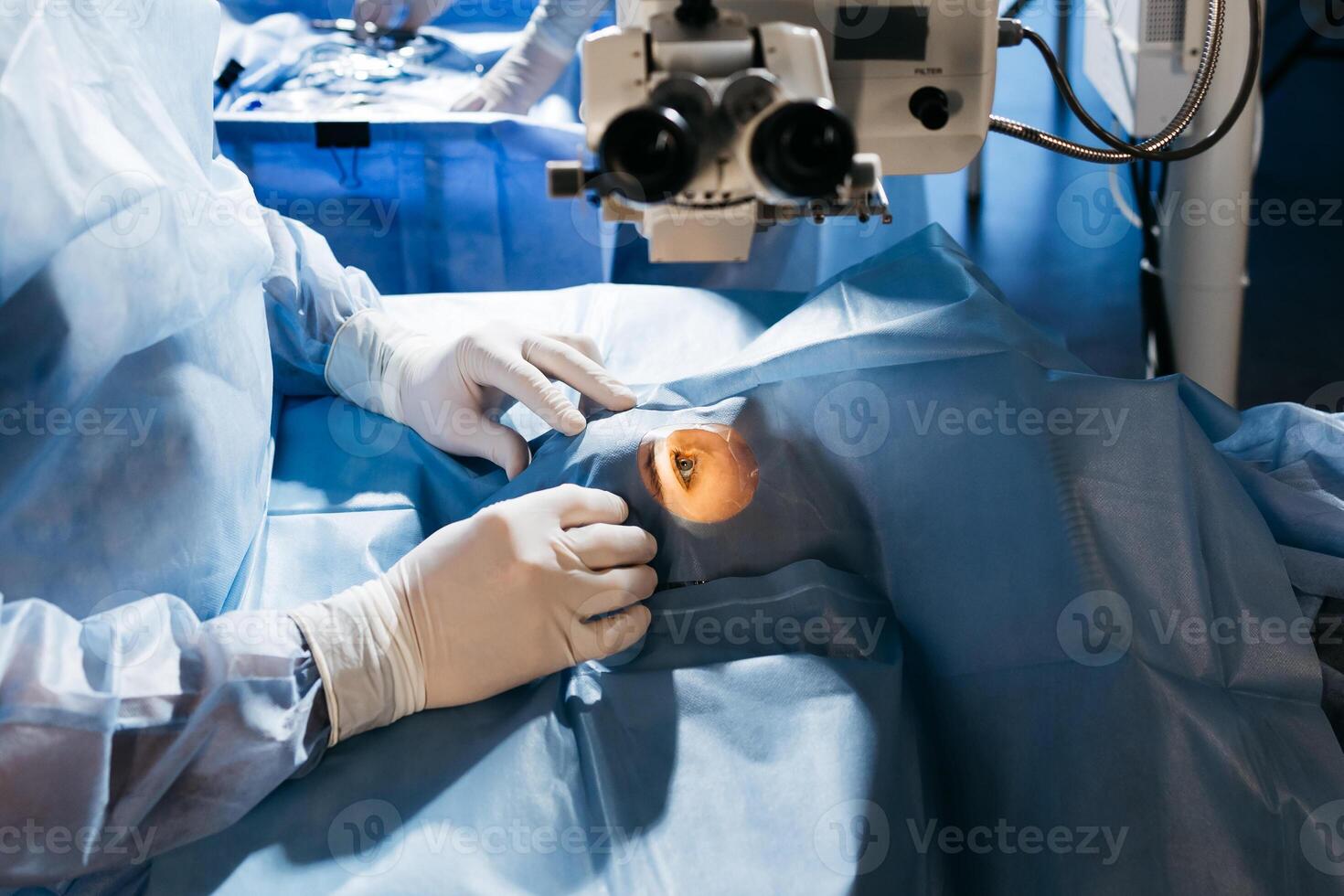 Vision correction with microscope. Surgeon's hands in gloves performing laser eye vision correction. ophthalmology , medicine, people health concept photo