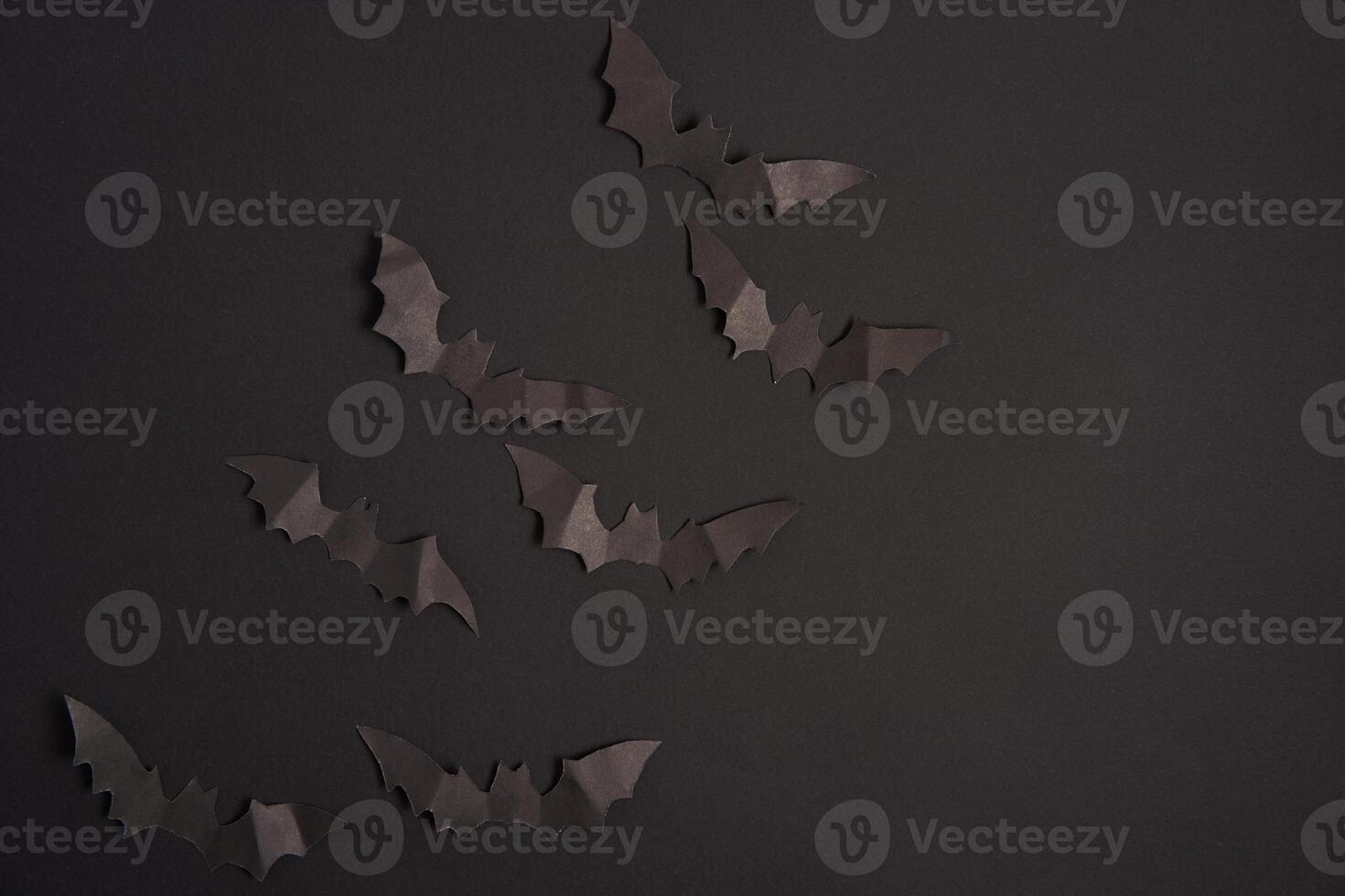 Halloween decoration concept black paper bats black cardboard background photo