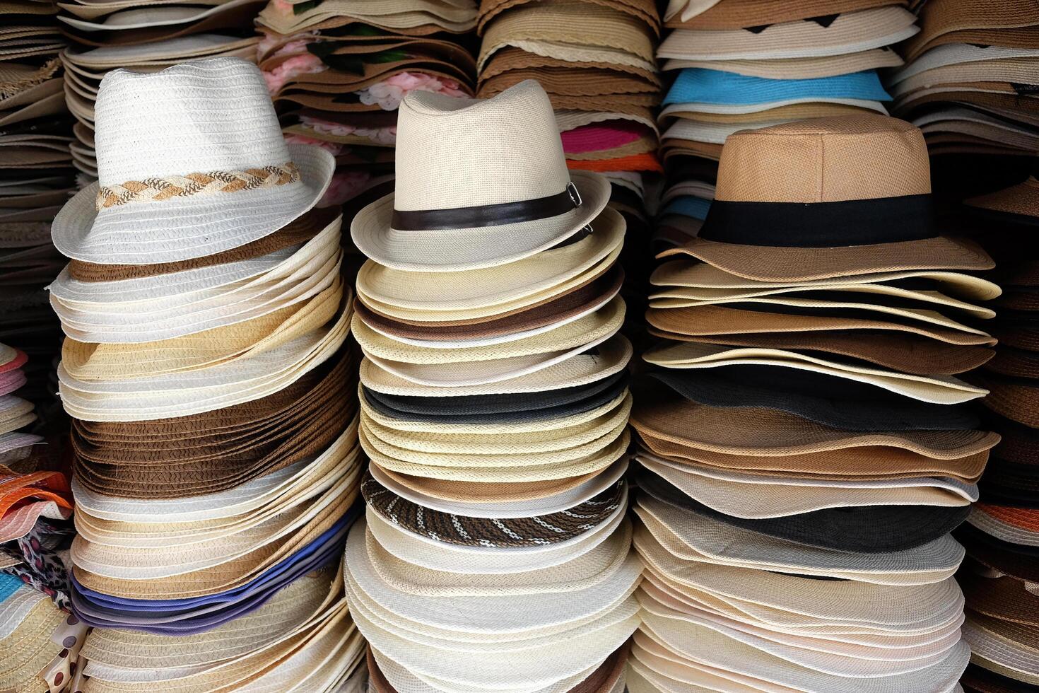 Vintage stacked straw hats in local souvenir shop in Thailand photo