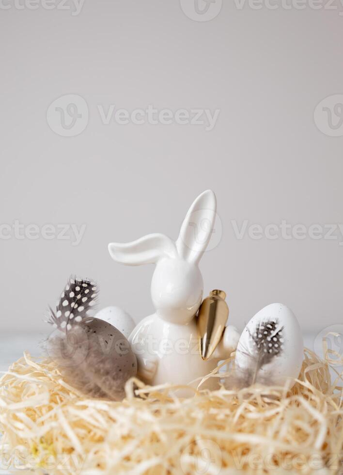 Easter bunny and eggs in nest. Copy space photo