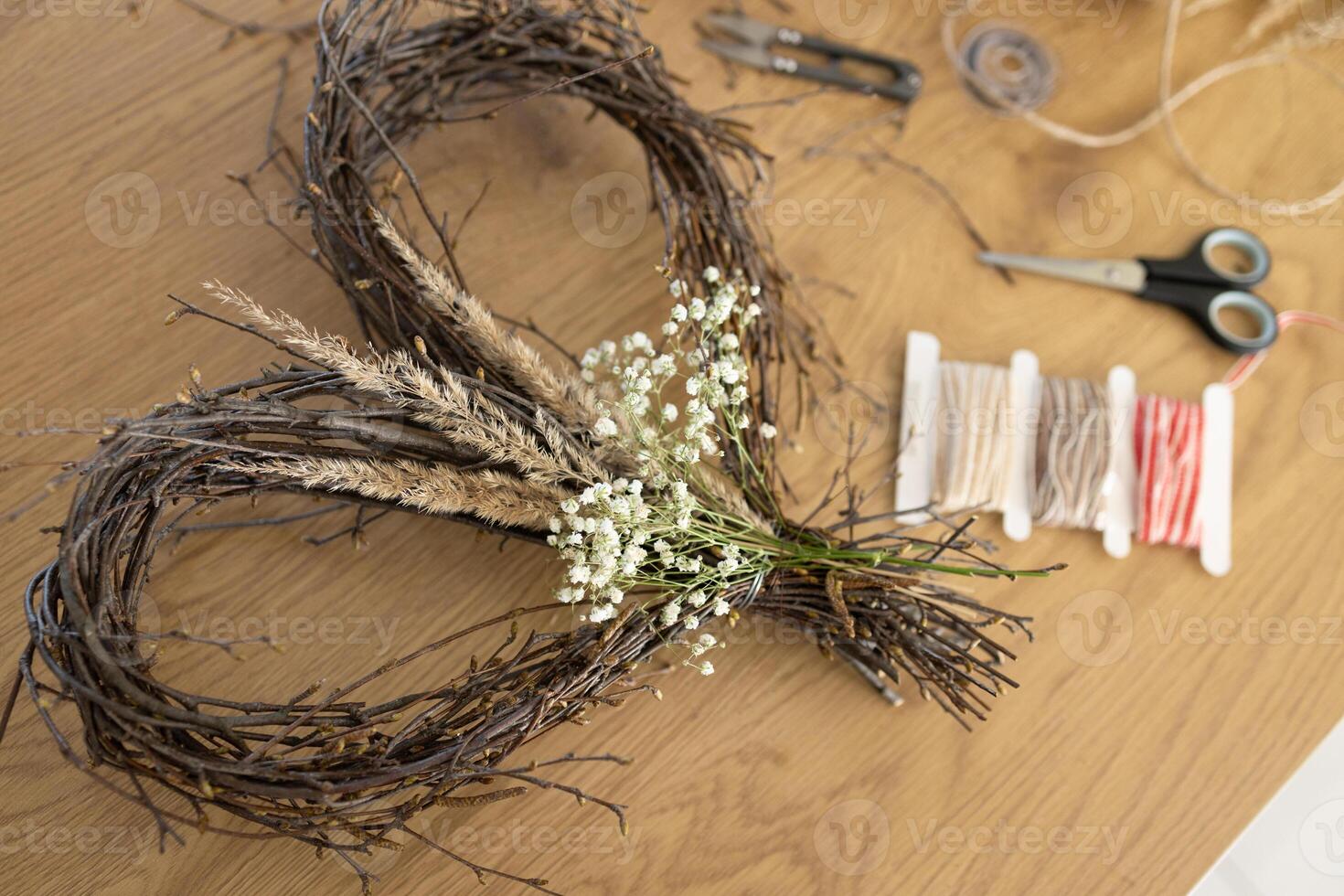 Wicker heart shaped wreath of birch branches and supplies for DIY making photo