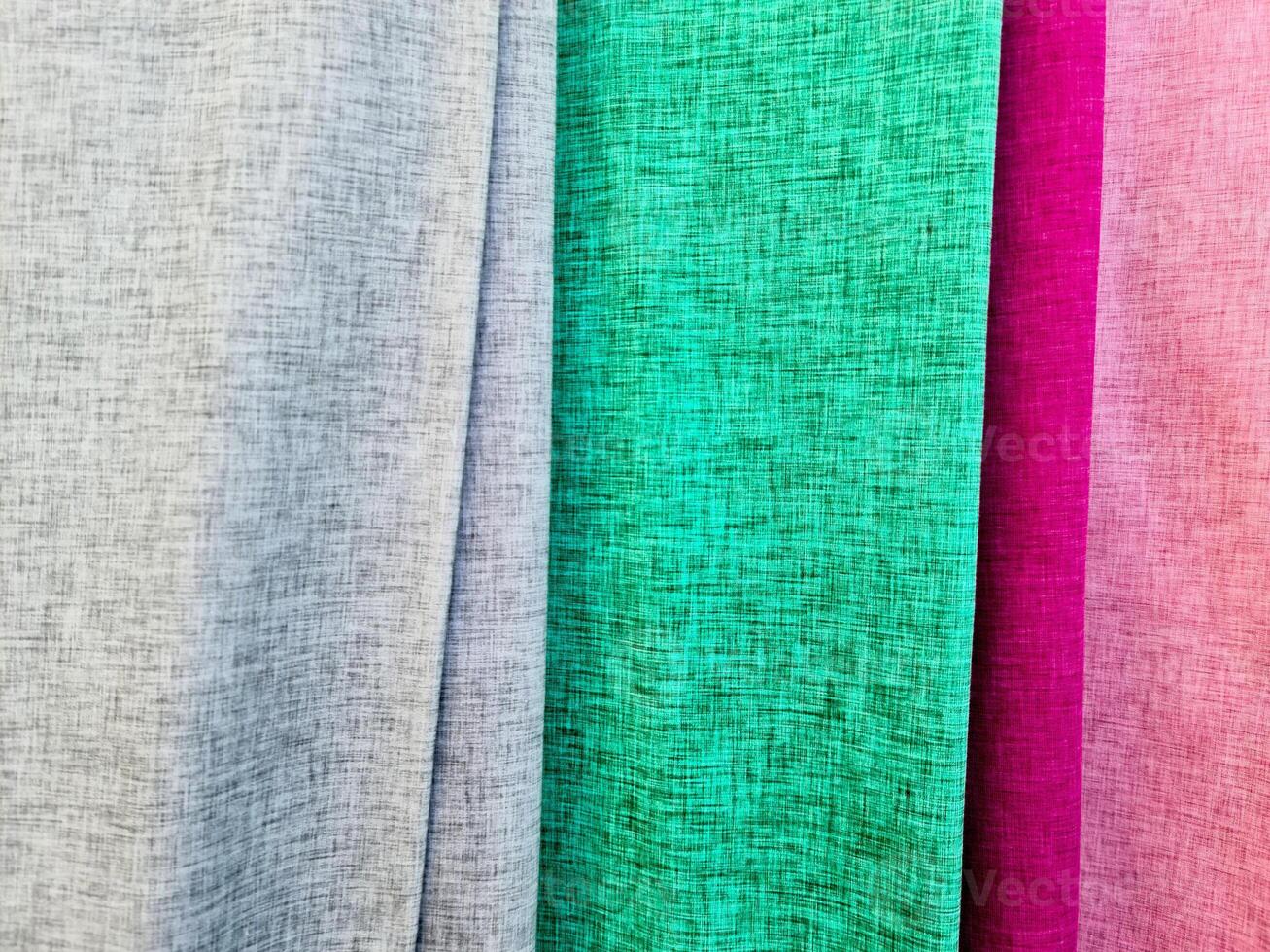 Detailed close up view on samples of cloth and fabrics in different colors found at a fabrics market photo