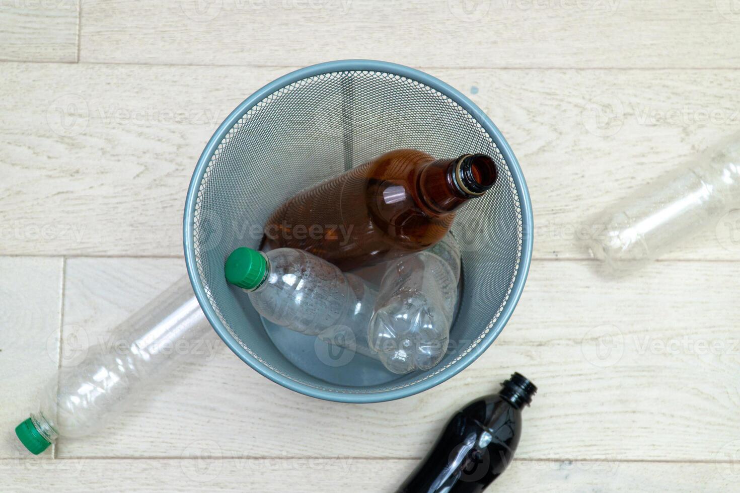 Spx different plastic bottles in the office trash can. Ecology and recycling of garbage from various raw materials photo