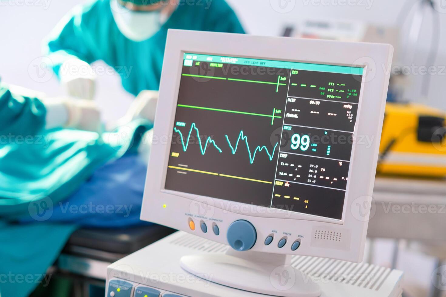 Blurred medical team performing a surgical operation in operating Room, Concentrated surgical team operating a patient, Selective focus on monitor photo