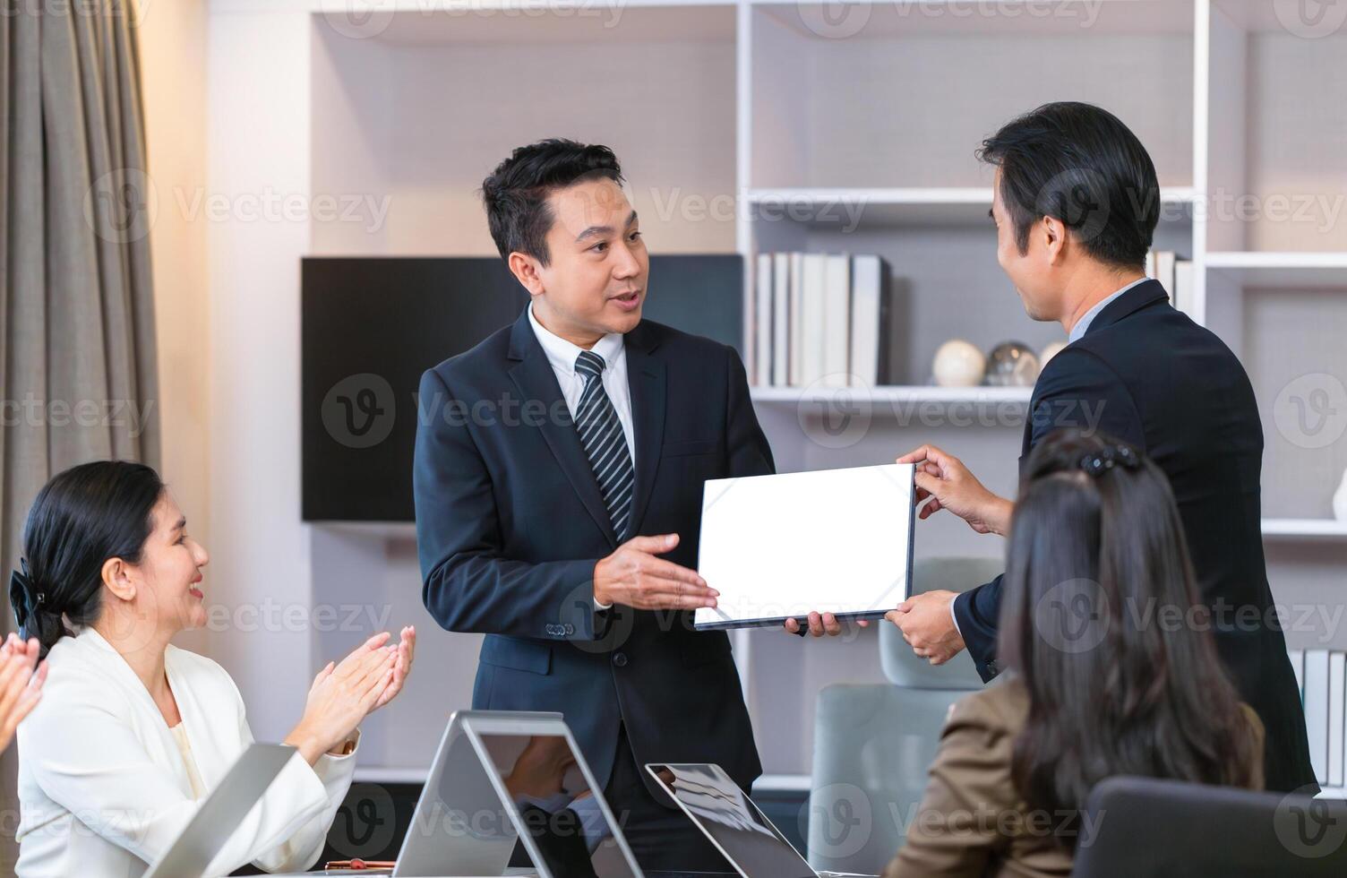 Employee gets a certificate of achievement, Businesspeople with certificates in the office, Manager give appreciation certificate to employees for achievement photo