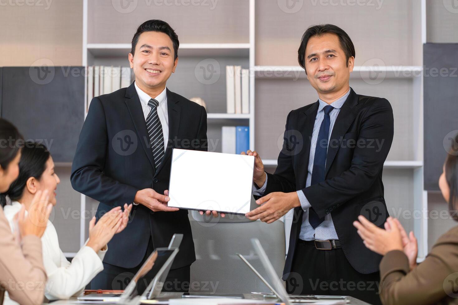 Employee gets a certificate of achievement, Businesspeople with certificate in the office, Businessman giving appreciation certificate to employee for achievement photo