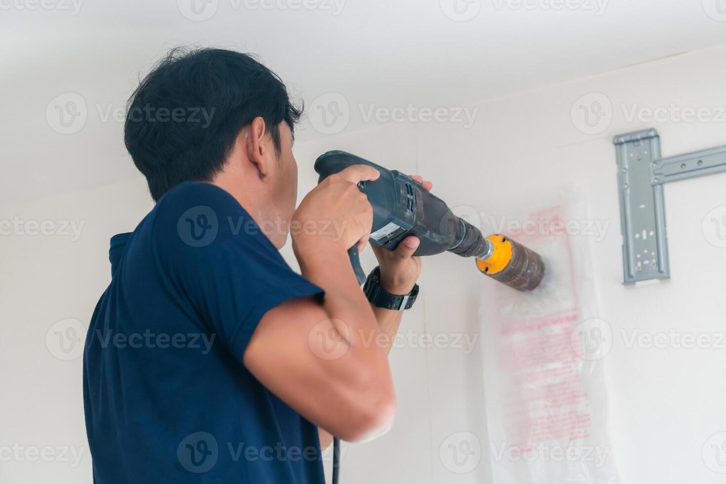 Technician man drilling to concrete wall with core drill machine to install modern air conditioner Maintenance and servicing concepts 41511746 Stock Photo at Vecteezy