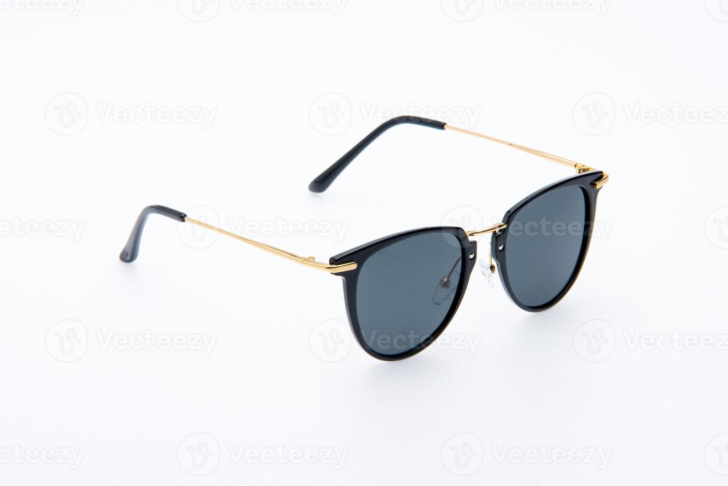 Fashion sunglasses black and gold frames on the white background. photo