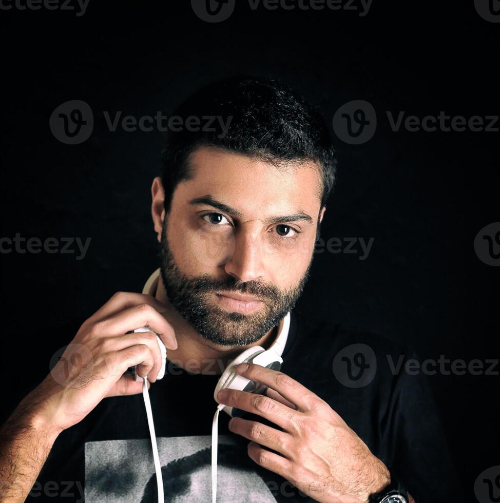 young DJ posing with his headphones photo