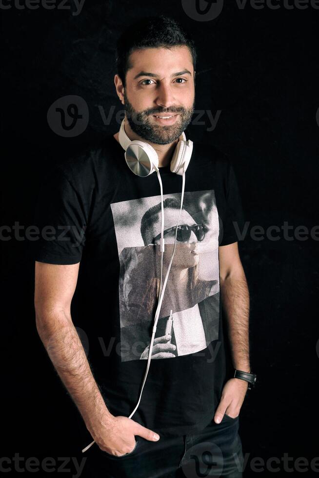 young DJ posing with his headphones photo