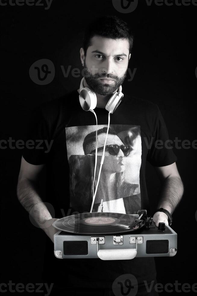 young DJ posing with his headphones photo