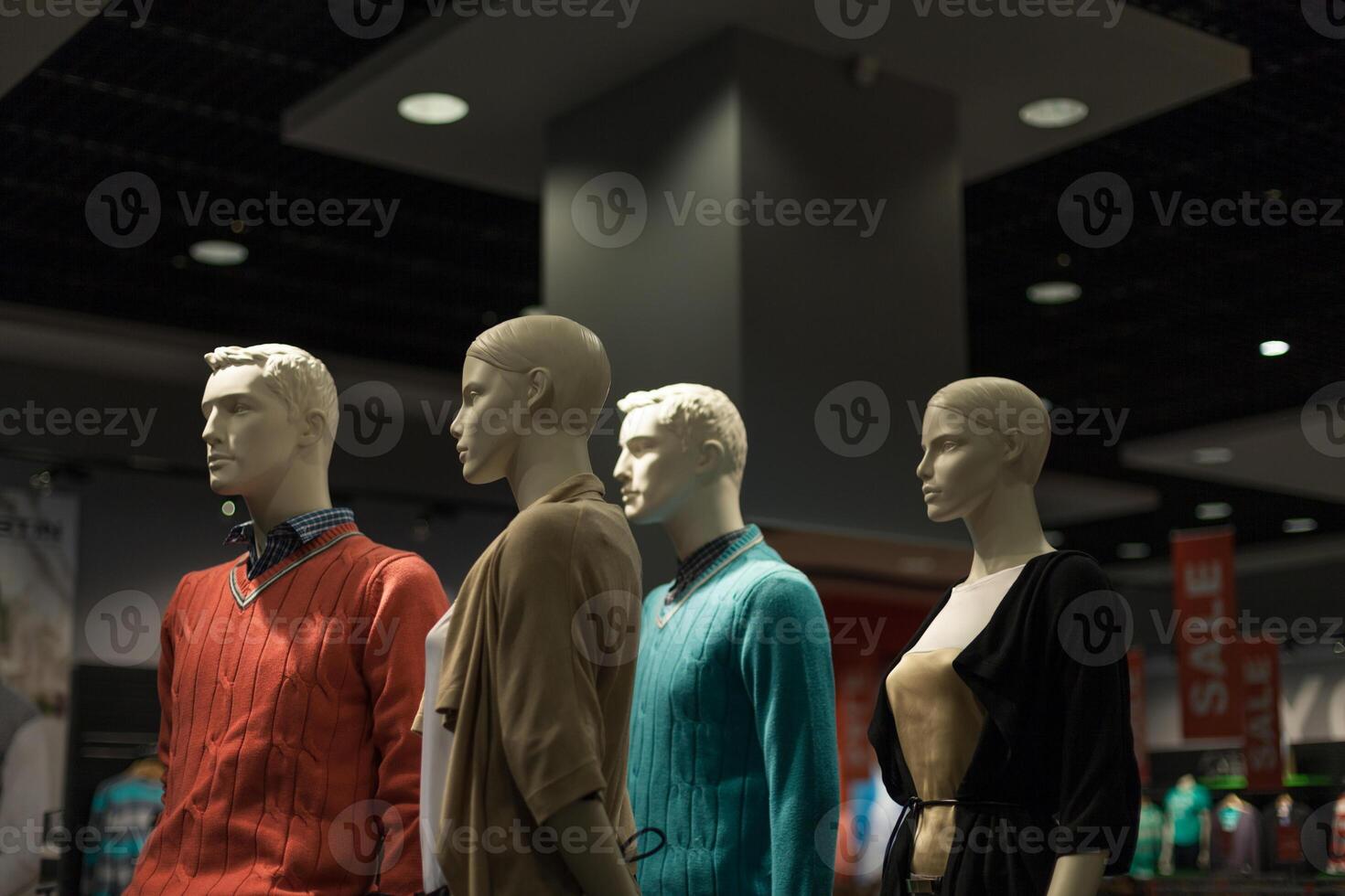 Four male and female mannequins in the store dressed photo