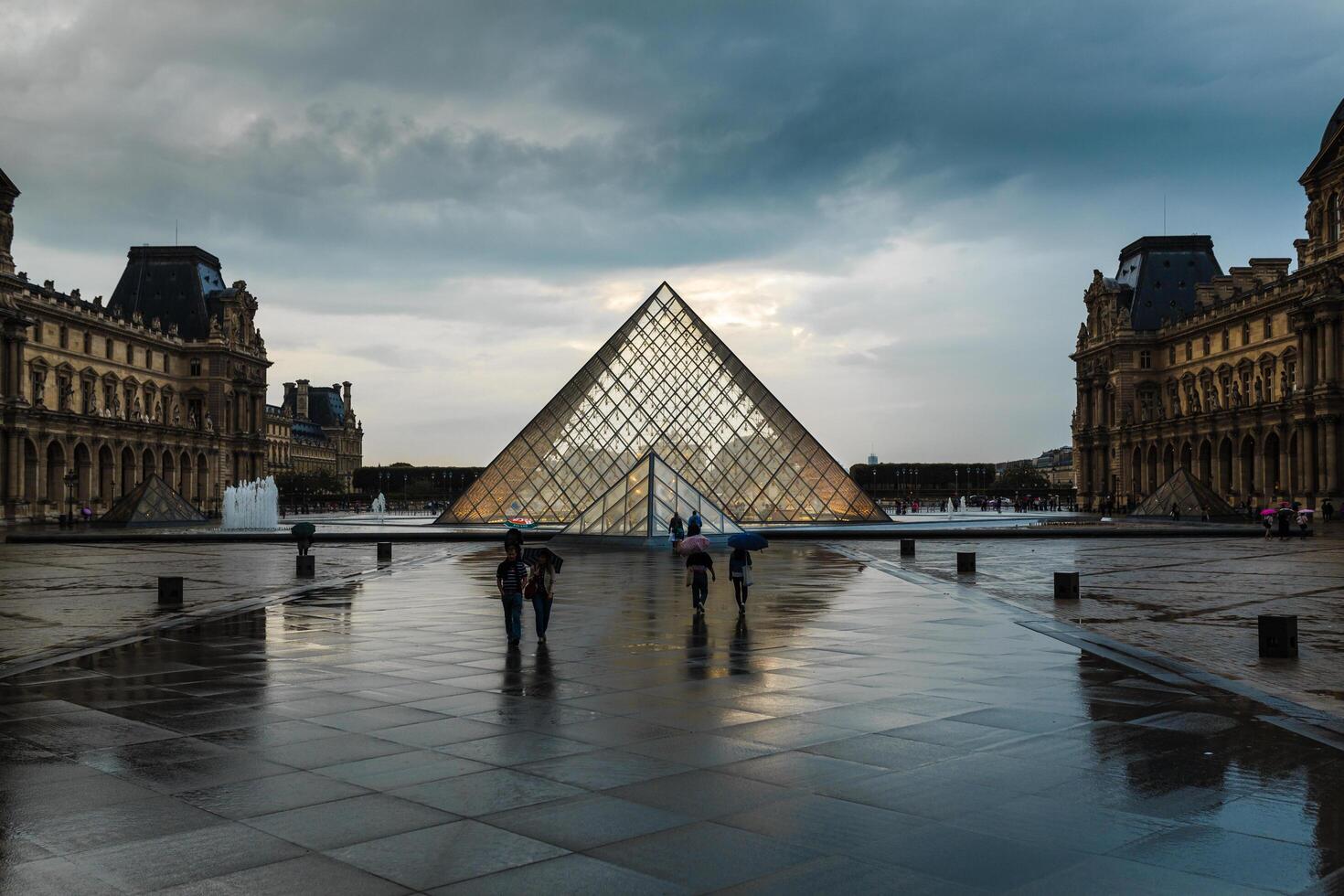PARIS, FRANCE - June 01, 2018 View of famous Louvre Museum with Louvre Pyramid at evening sunset. Louvre Museum is one of the largest and most visited museums worldwide photo
