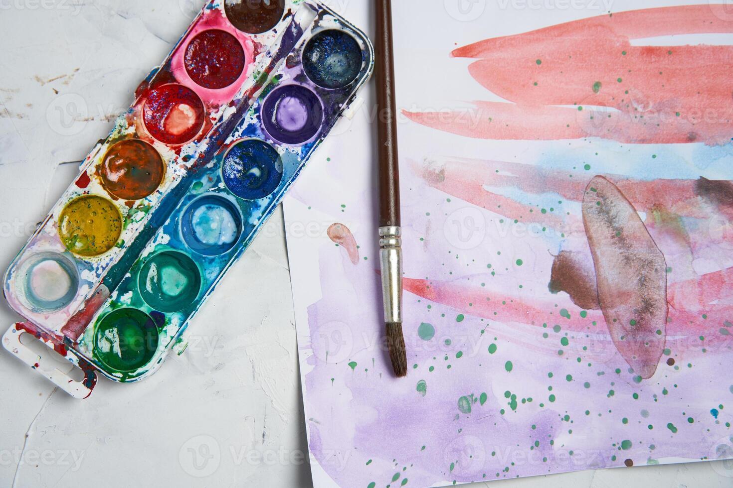 Set of watercolor paints on white background. Brushes drawing. Creative background. School for teaching drawing. photo