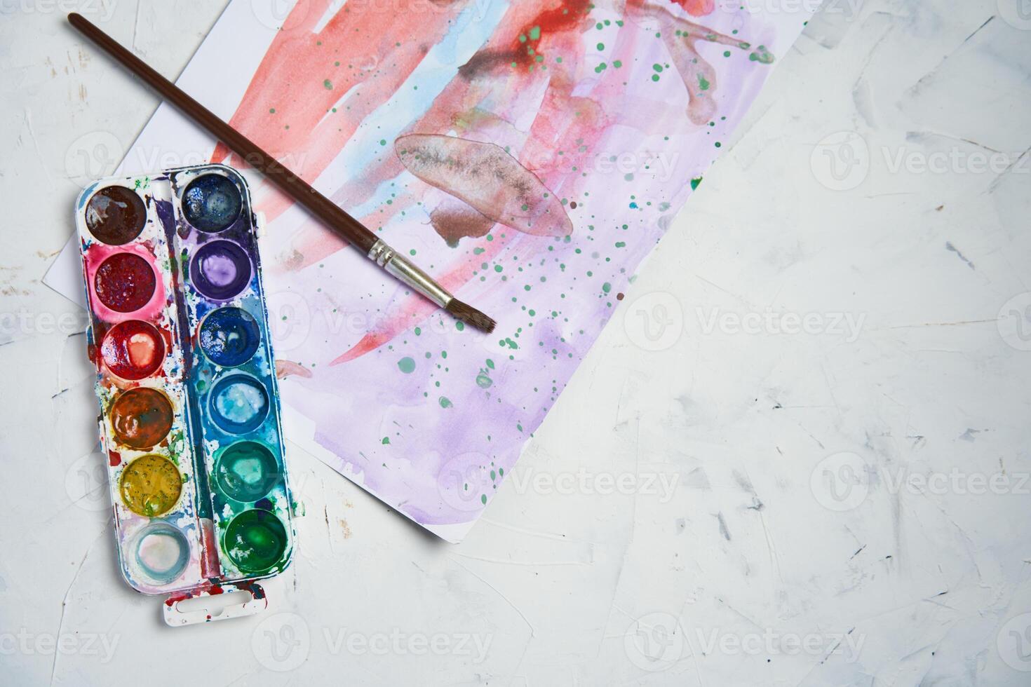 Set of watercolor paints on white background. Brushes drawing. Creative background. School for teaching drawing. photo