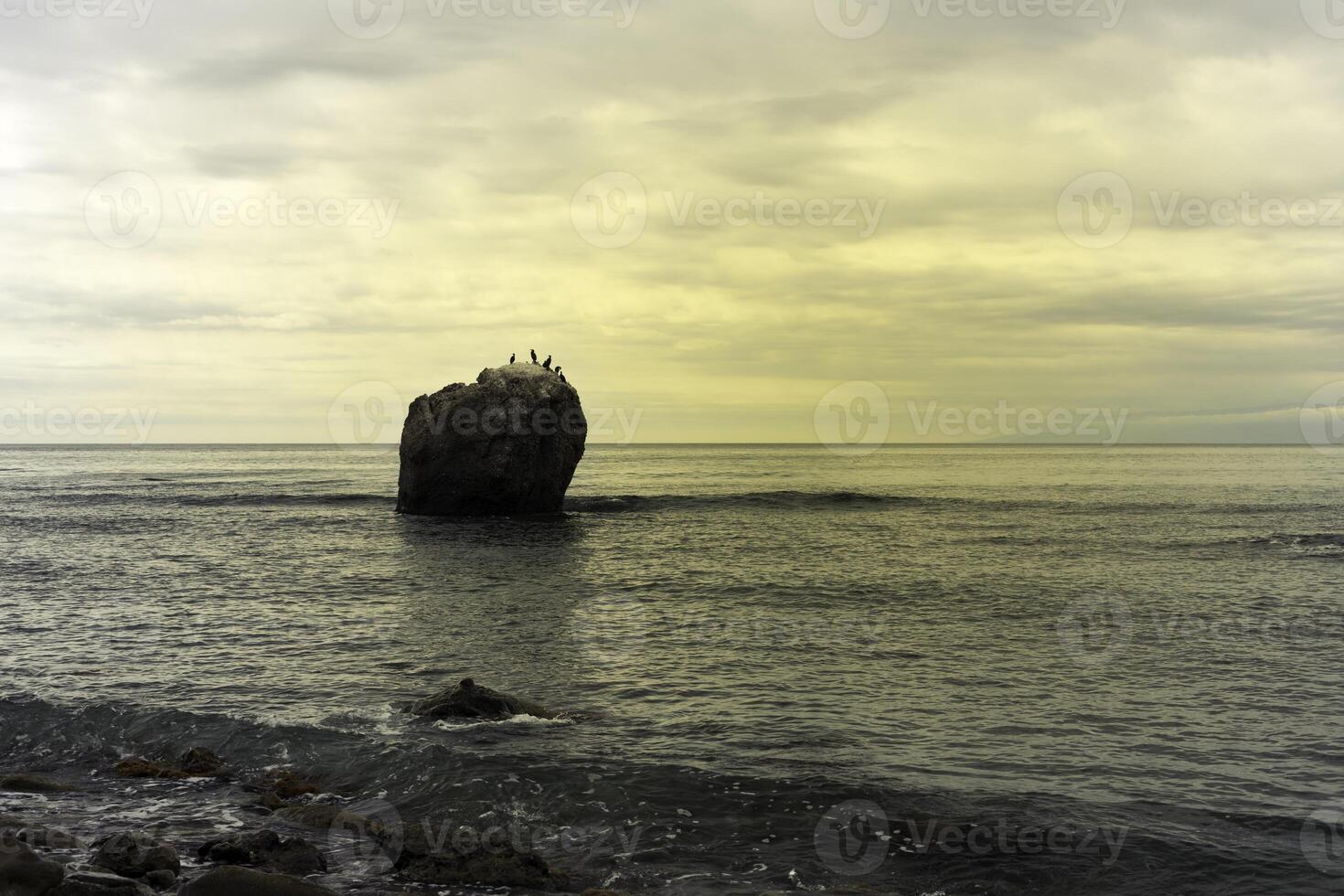 big stone in the sea photo