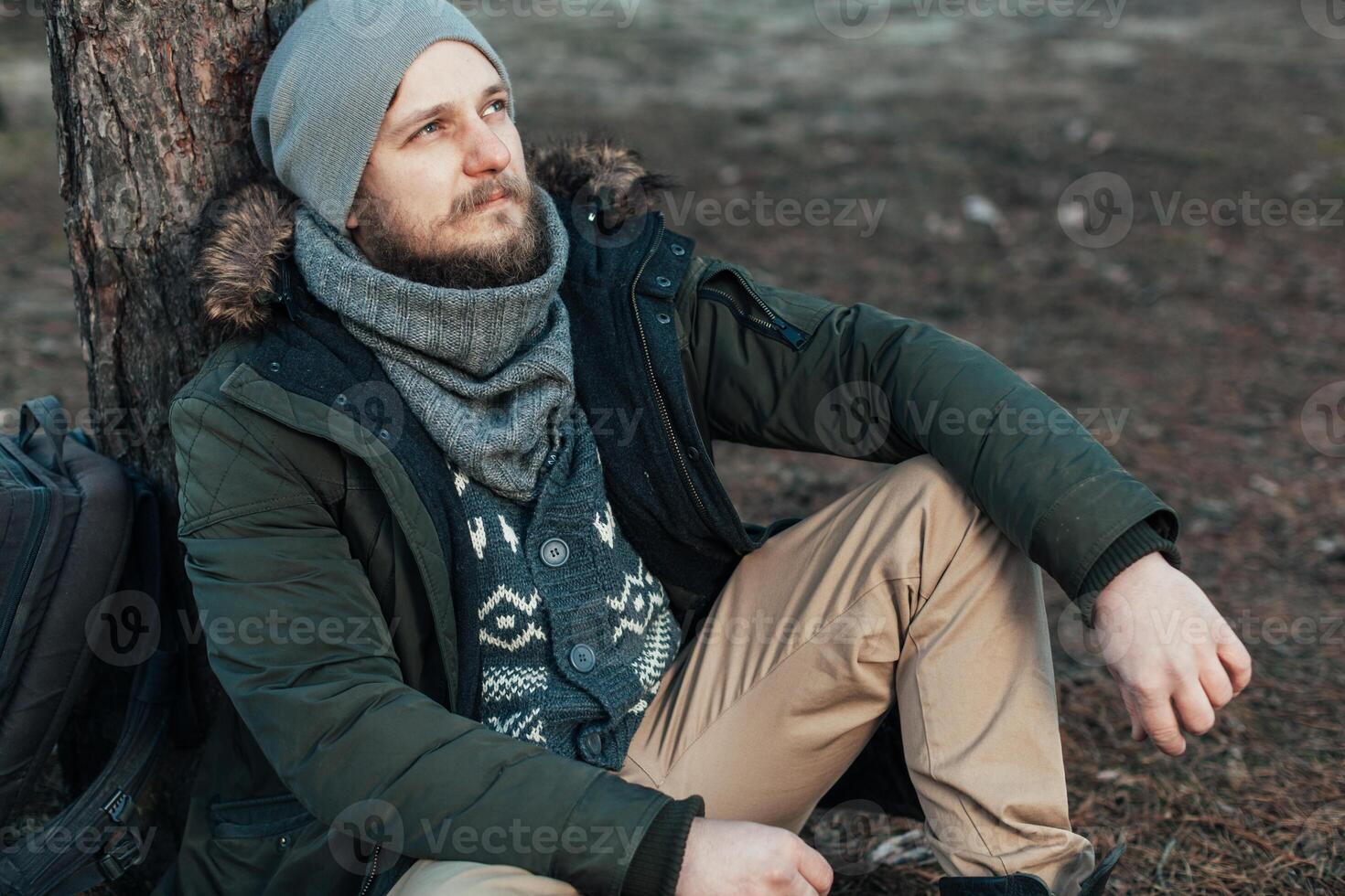 Pensive hipster guy wanderlust with touristic backpack enjoy tranquility during exploring nature environment, photo