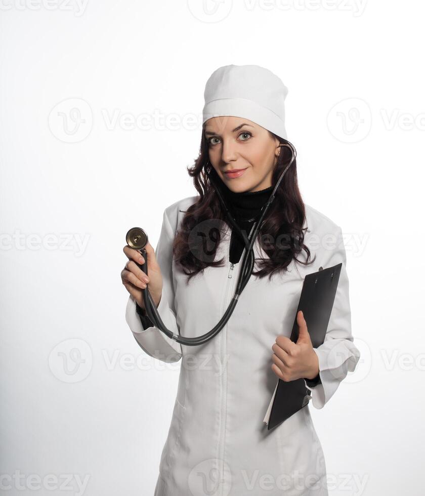 a woman in a white lab coat holding a stethoscope photo