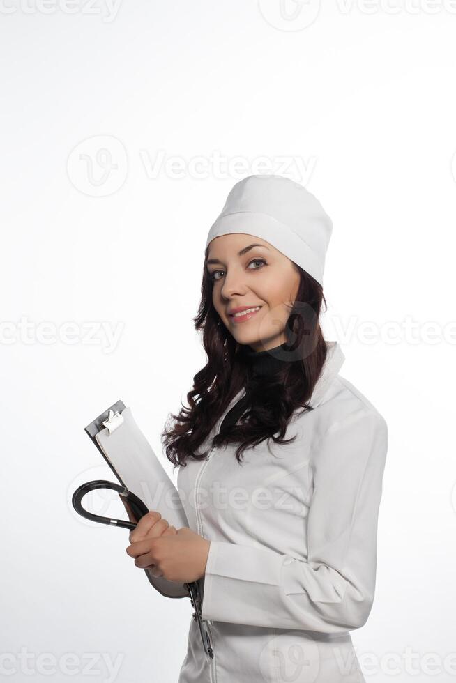 a woman in a white lab coat holding a clipboard photo