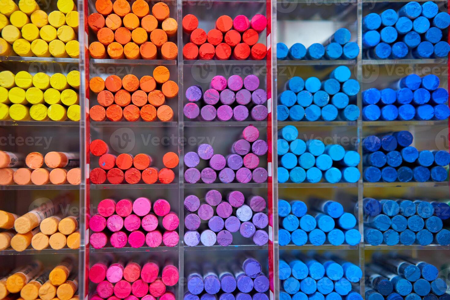 Multicolored pastel crayons art store in wooden cells photo