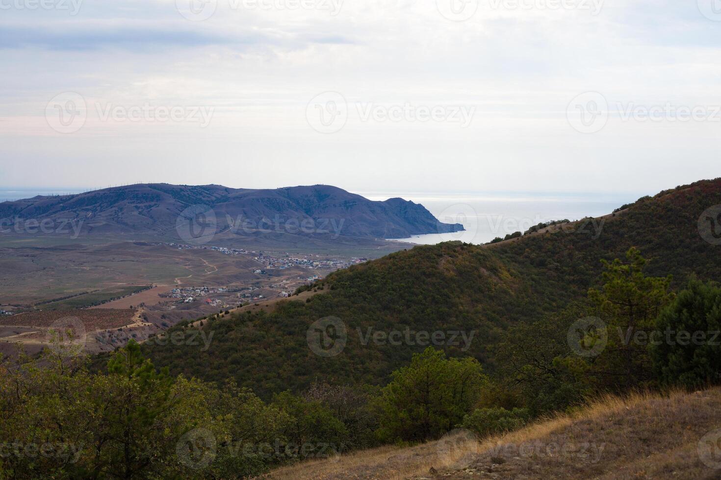 city by the sea near the mountains under a beautiful sky photo