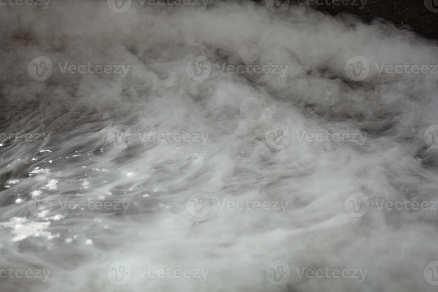 Thick white smoke on a background of black ceramic tiles. photo