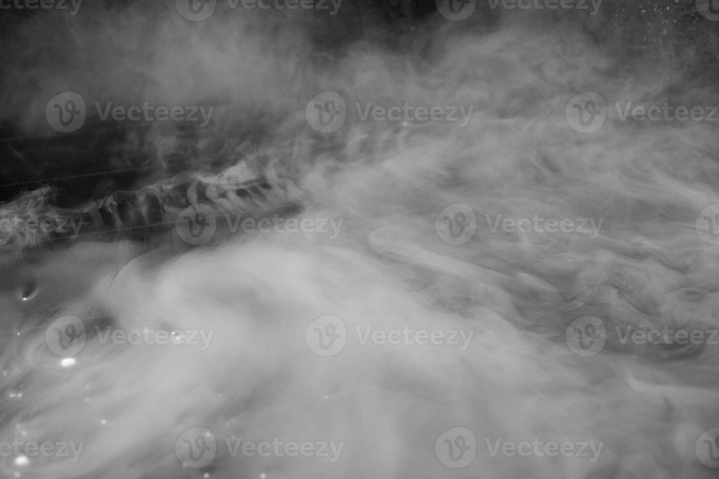 Thick white smoke on a background of black ceramic tiles. photo