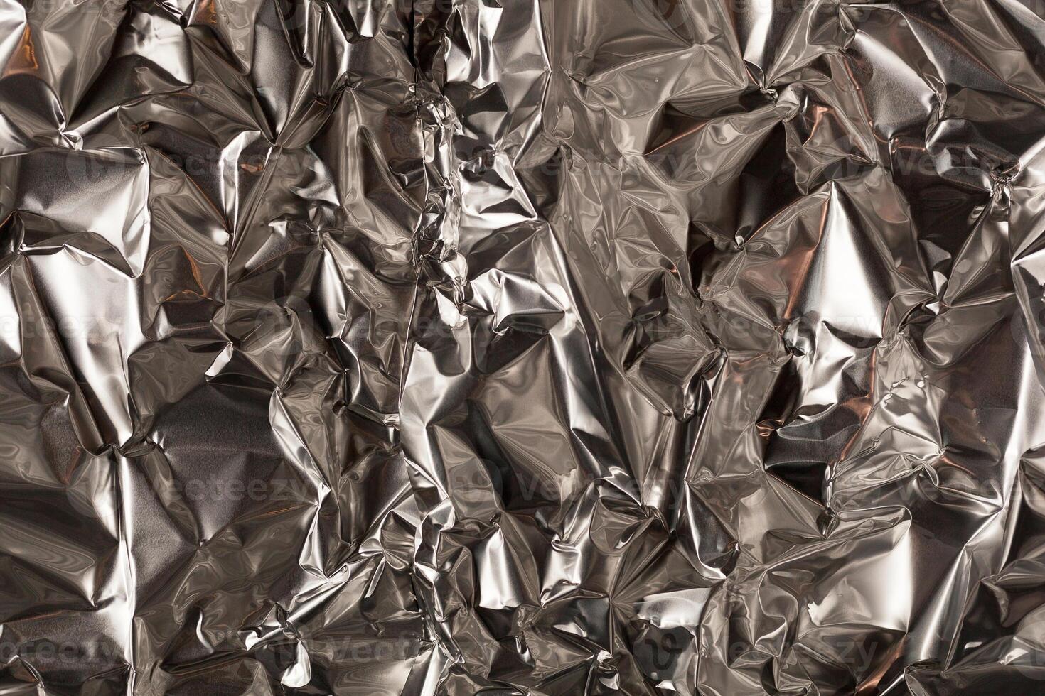 Full frame take of a sheeT of crumpled silver aluminum foil photo