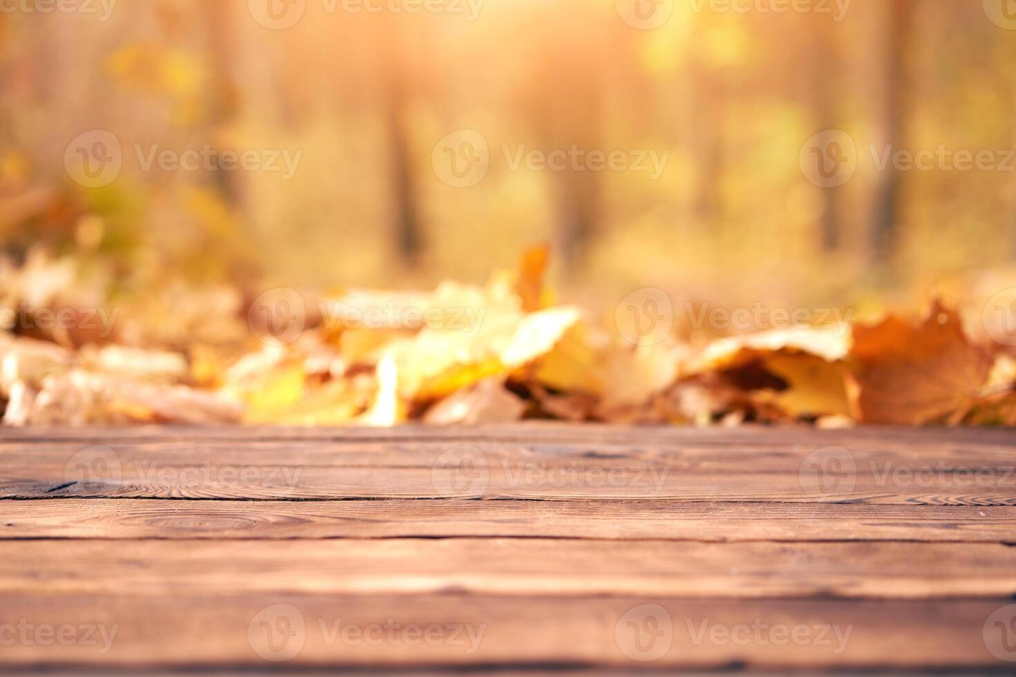Empty wooden table autumn leaves nature bokeh background with a country outdoor theme,Template mock up for display of product photo