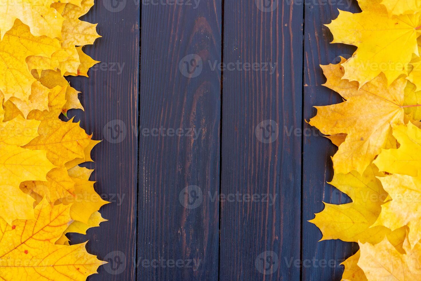 Autumn leaves frame on wooden background top view Fall Border yellow and Orange Leaves vintage wood table Copy space for text. photo