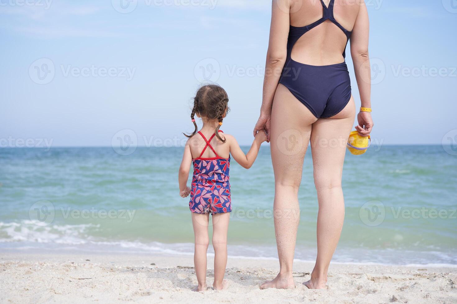 swimsuit daughter Mother daughter beach together rear view Unrecognizable caucasian woman  little girl swimwear standing seaside back. 41482357 Stock Photo at Vecteezy