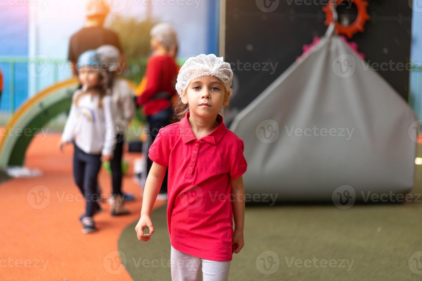 Cute little girl climber dressed protective hat before dress up helmet standing photo