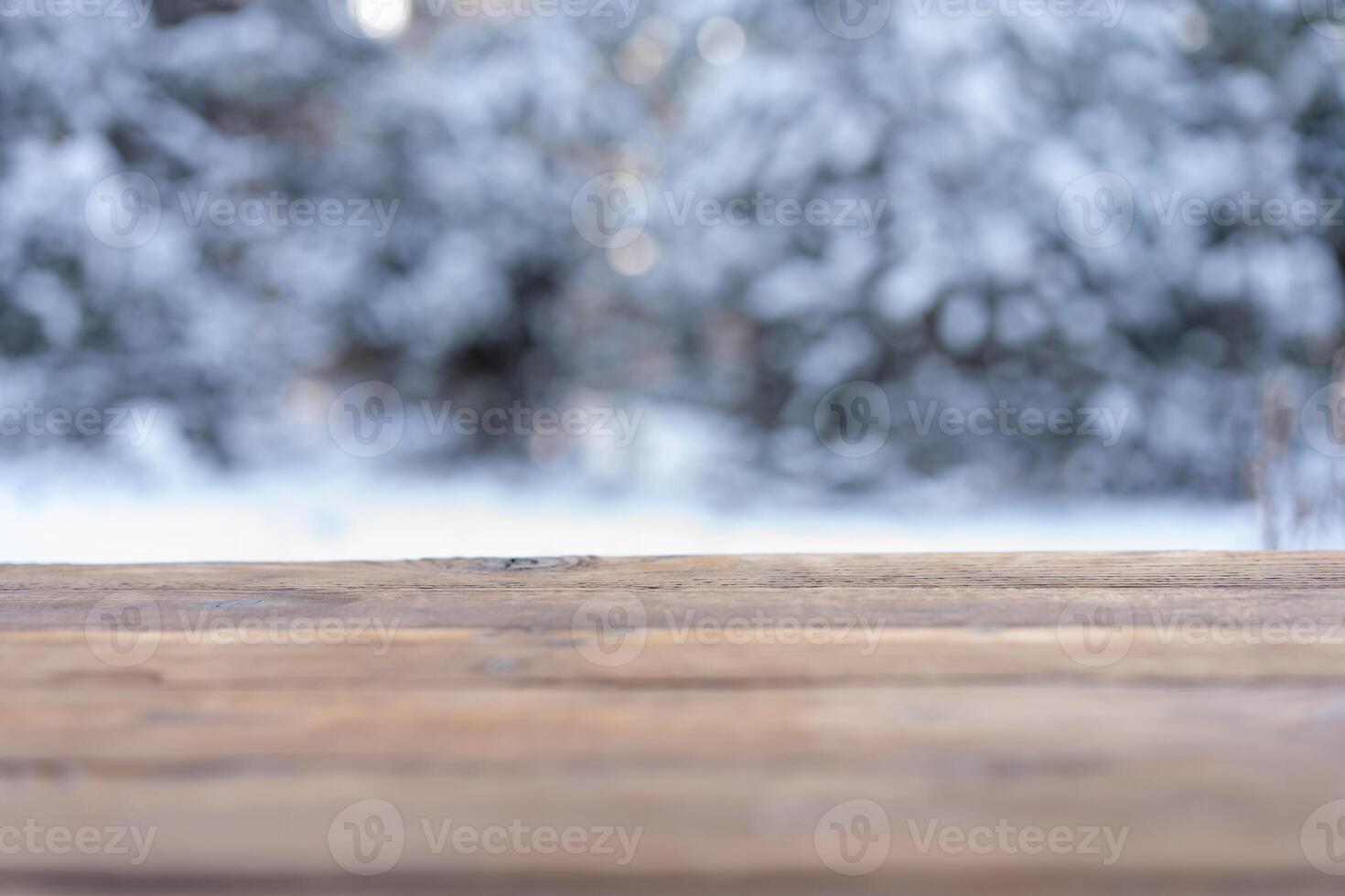 Beautiful winter scene. blurred background of snowy christmas nature background, Wood table top on shiny bokeh. For product display Christmas time mock up photo