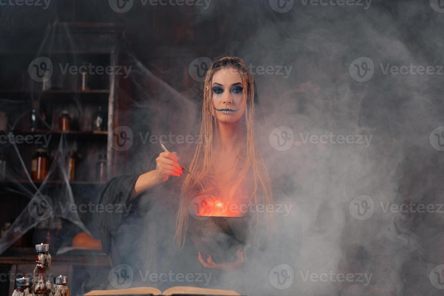 Víspera de Todos los Santos, bruja utilizar magia libro y caldera preparar veneno o amor poción foto