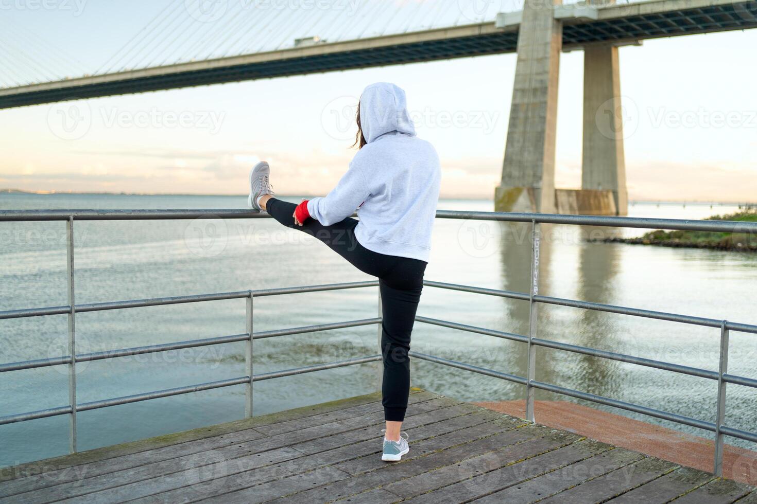 Athlete woman stretching legs outdoor photo