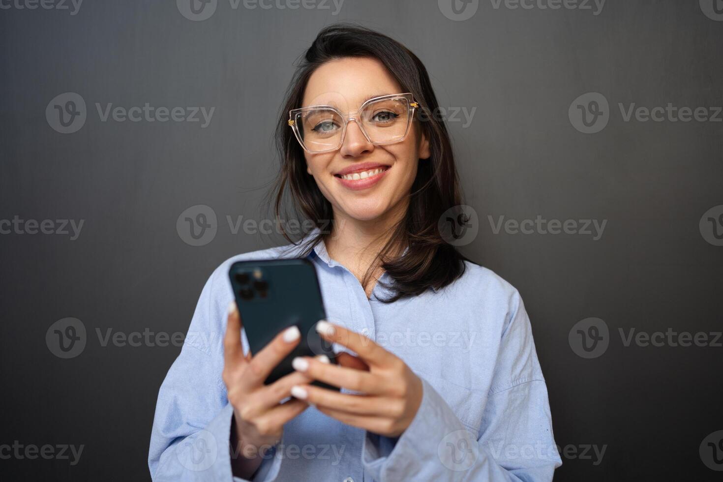 Woman use smartphone isolated on black photo