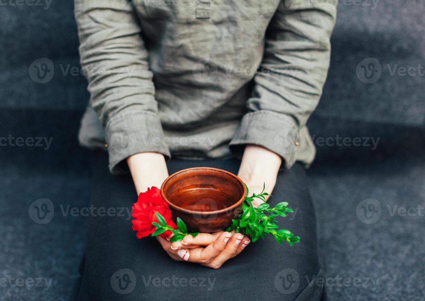 Woman offers hot tea in a vintage ceramic cup. photo