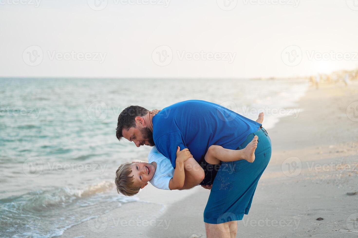 Father son spending time together sea vacation Young dad child little boy walking beach photo