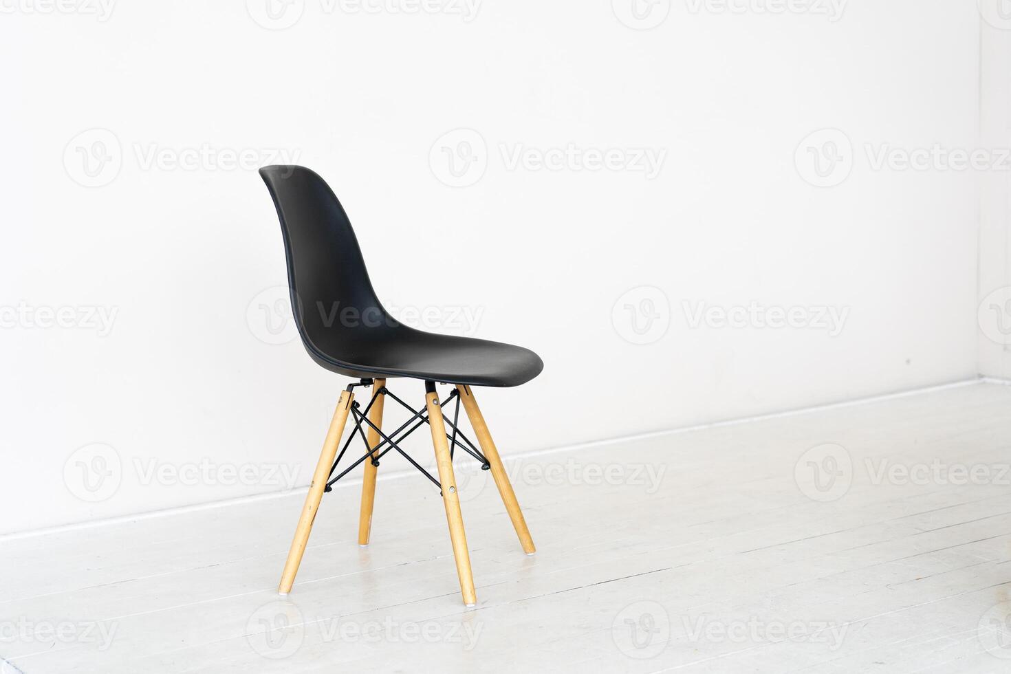 Black seat chair on white floor and white wall background photo